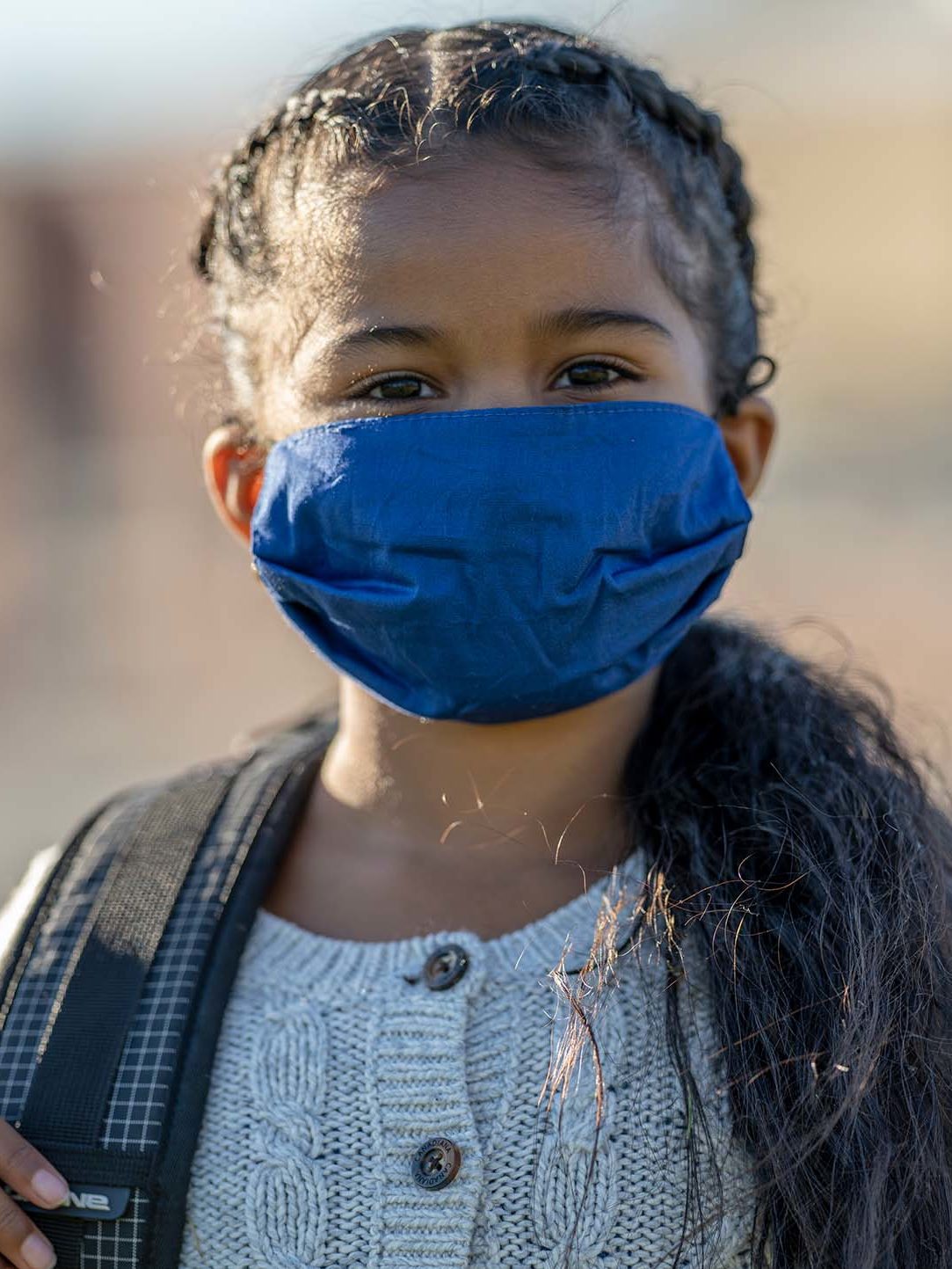Portrait of a student wearing a protective face covering while on school property during the COVID-19 outbreak.